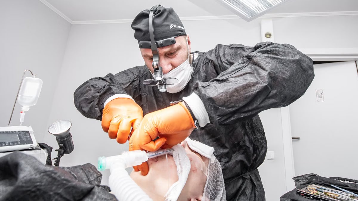 A surgeon operating on a patient in a hospital operating room, showcasing advanced medical procedures.